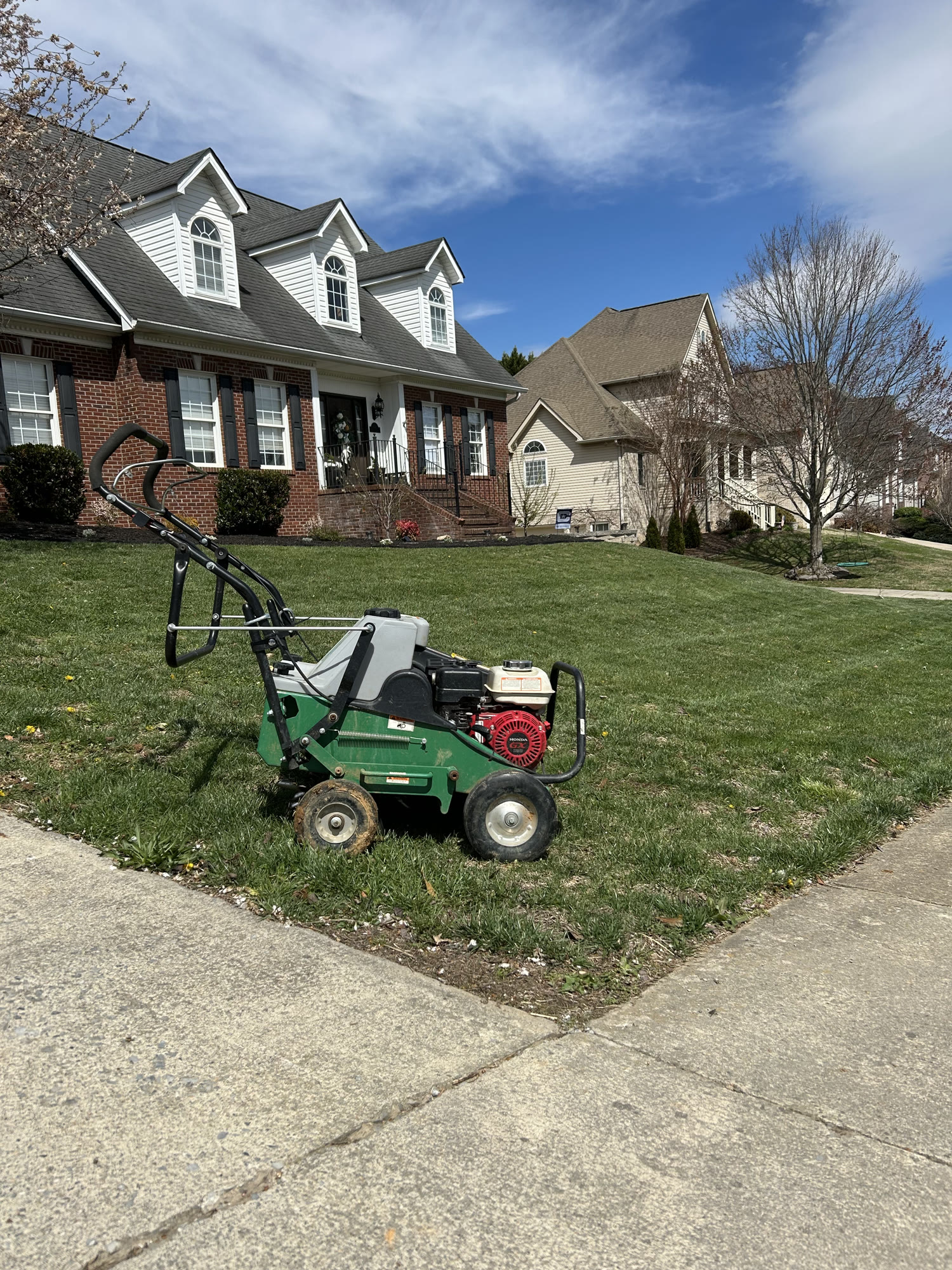 Professional aeration equipment on a residential lawn