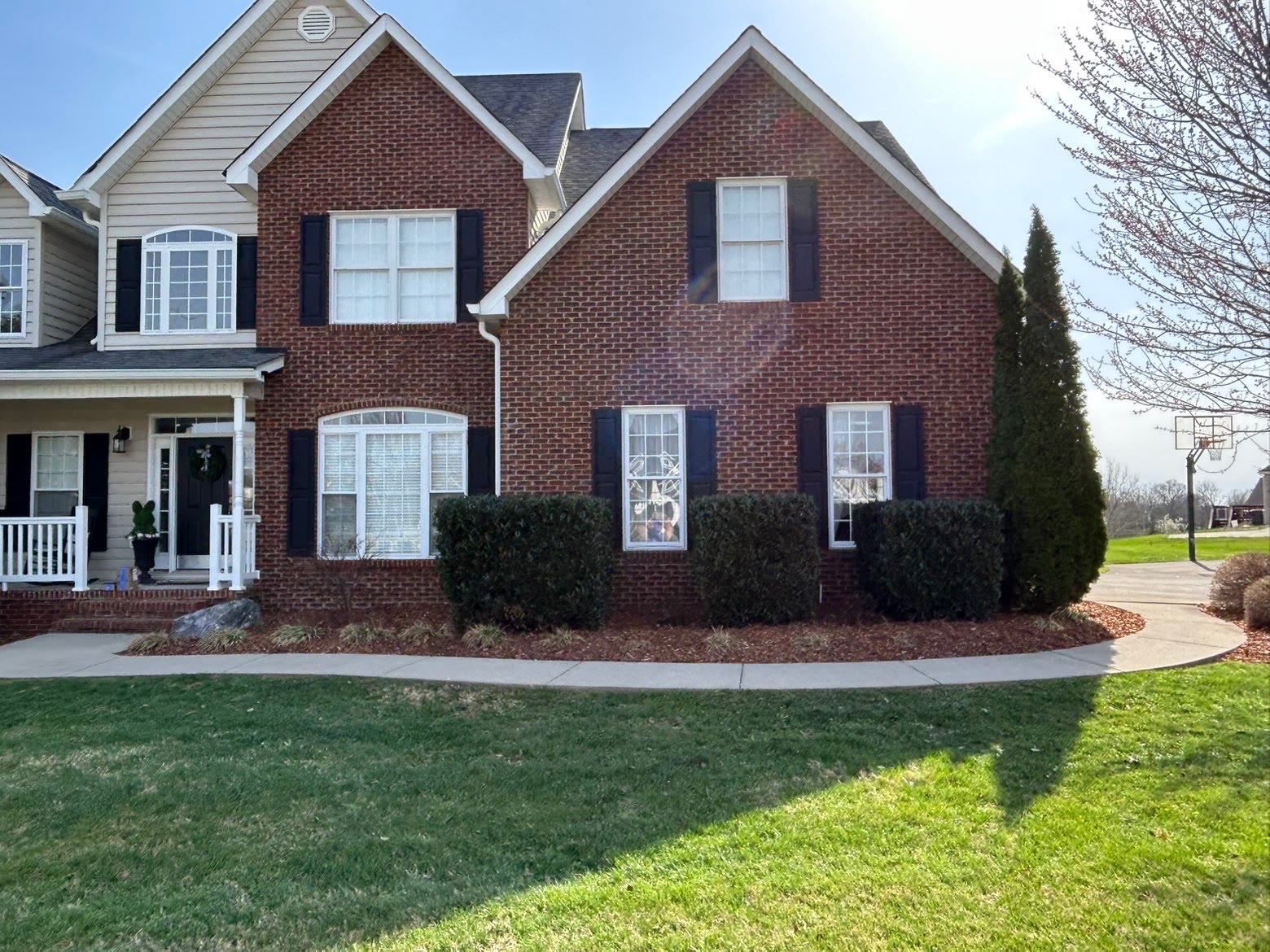 Fresh mulch, trimmed shrubs, and a manicured lawn on a Bristol-area home