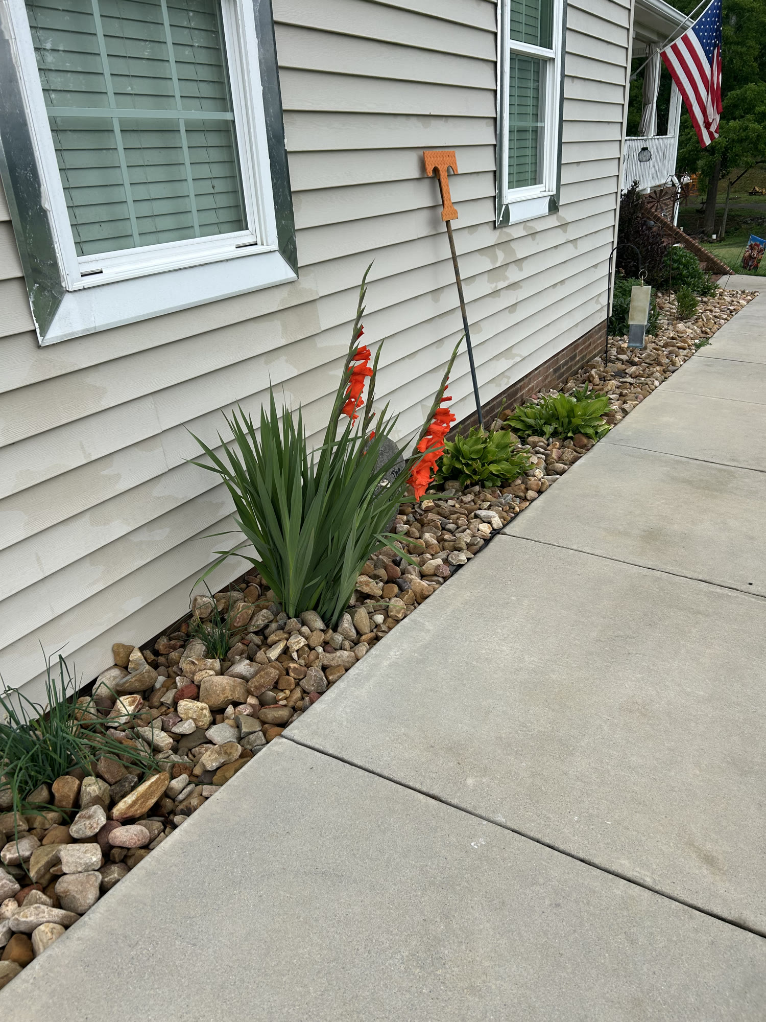 River-rock landscape bed with seasonal plantings