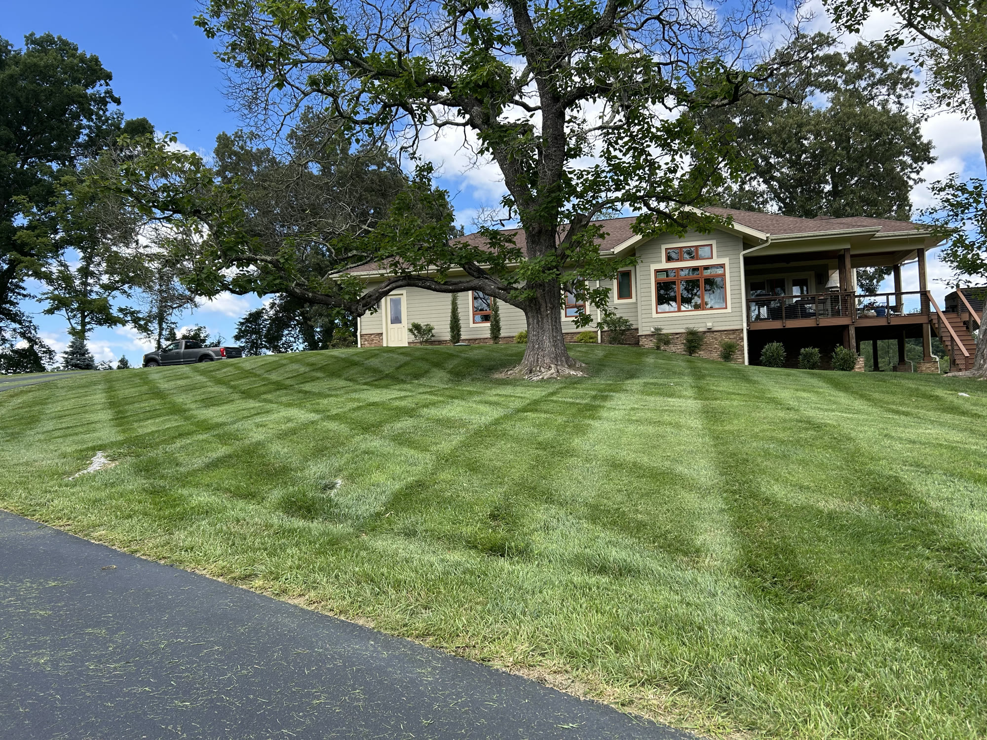 Professionally striped lawn and home maintained by Worsham's Outdoor Services in Bristol, TN