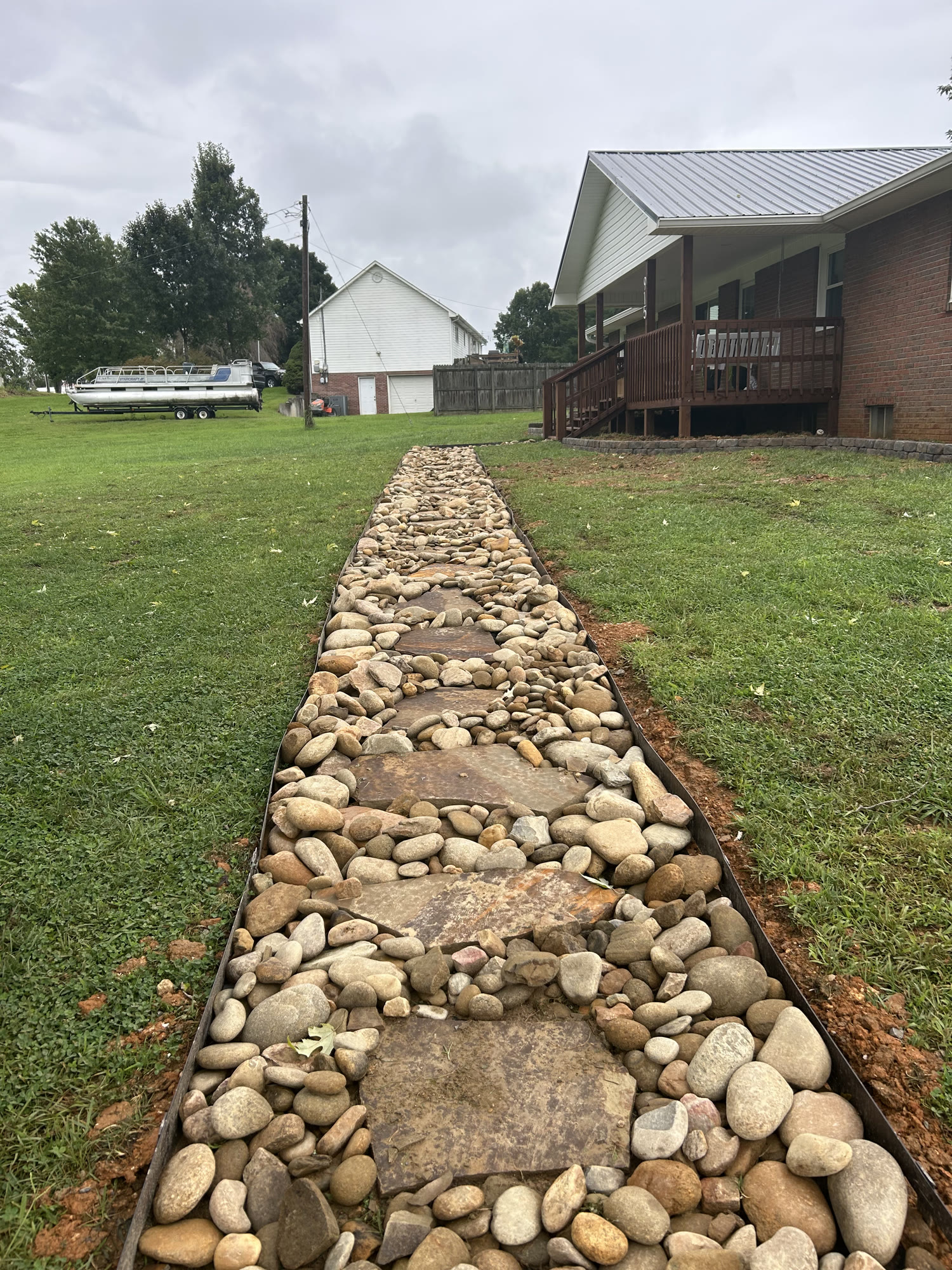 Newly installed flagstone and river-rock walkway